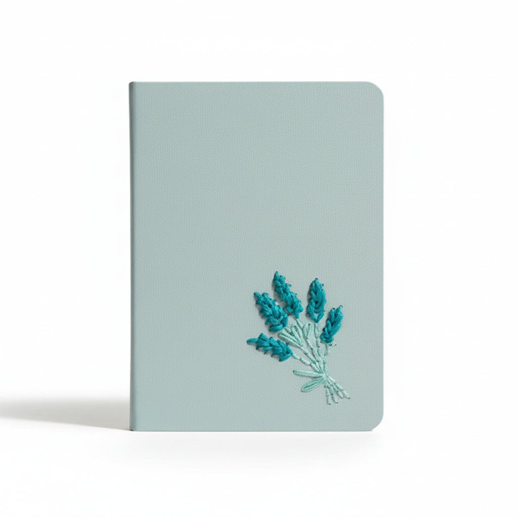 Light blue notebook with embroidered lavender design on a white background