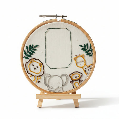 Embroidery hoop with embroidered animals on a white background