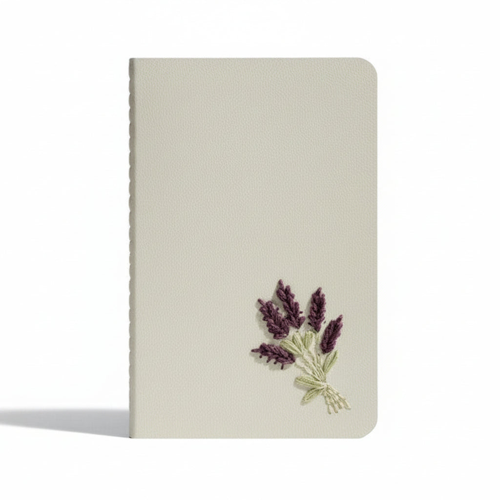 Notebook with embroidered lavender design on a white background