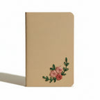 Beige notebook with floral embroidery on a beige background