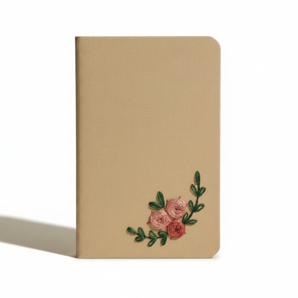 Beige notebook with floral embroidery on a beige background