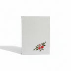 White pocket diary with floral design on a white background